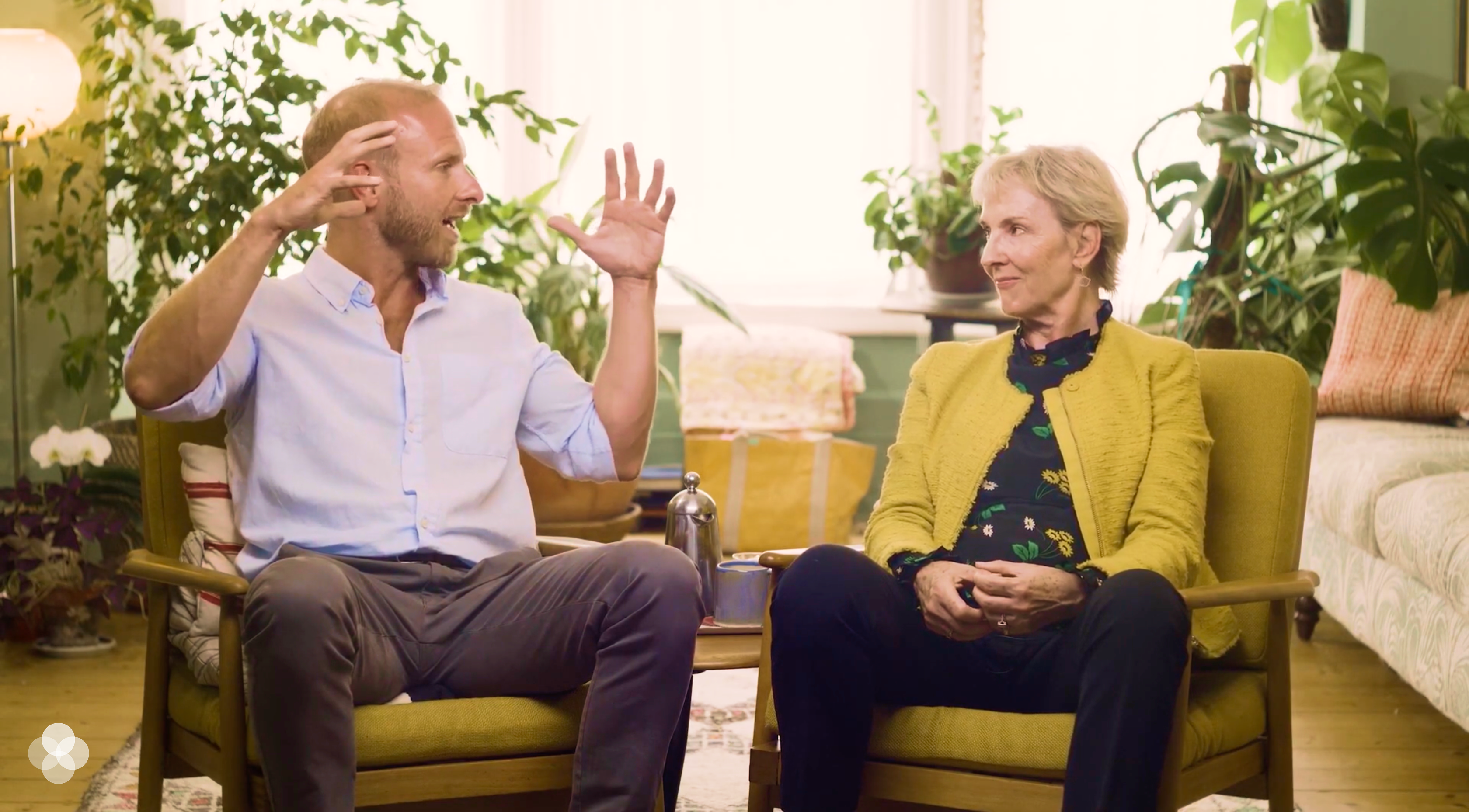 A still from the masterclass film, an interview with Julia Samuel in a plant-filled room.
